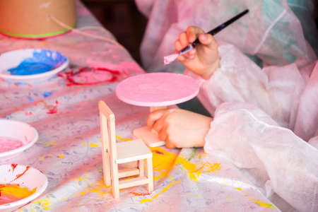 Young children decorating handmade wooden chairの写真素材