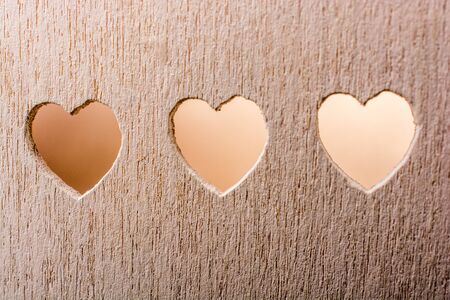 Heart shape holes on a wooden objectの写真素材