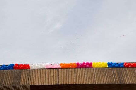 Color balloons on the roof of a buildingの写真素材