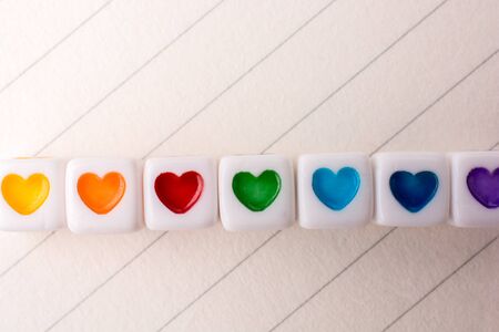 Colorful cubes with a heart placed on paperの写真素材