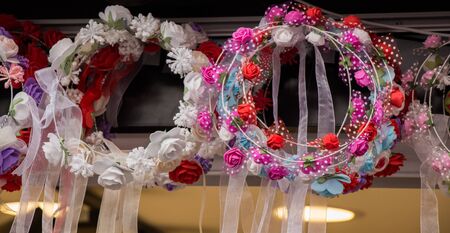 colorful crowns  for sale made of fake flowersの写真素材