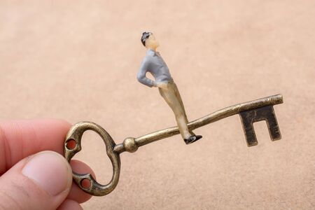 Hand holding a retro styled  golden color   decorative keyの写真素材