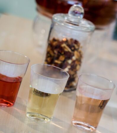 Herbal tea brewed in glass teapot and tea plant in in  glassesの写真素材