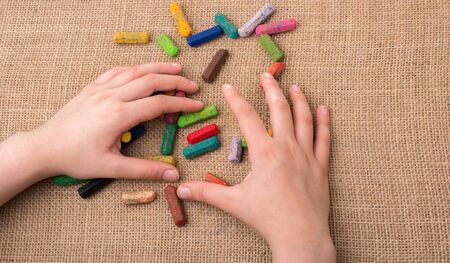 Used  color crayons and a hand holding someの写真素材