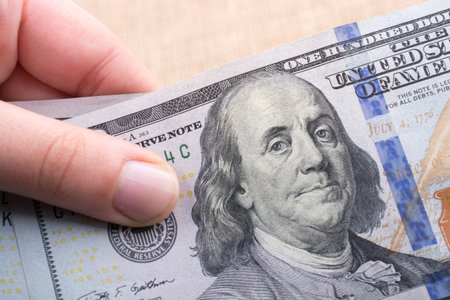 Close up of Benjamin Franklin face on 100 US dollar bill