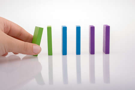 Colorful Domino Blocks in a line on a white backgroundの写真素材