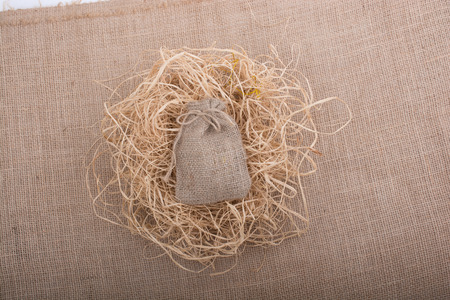 Sack placed on straw on canvas backgroundの写真素材