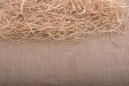 Straw placed on canvas as a backgroundの写真素材