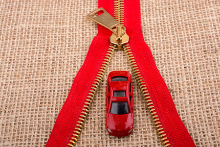 Toy car as a transportation devices in hand on a canvas backgroundの写真素材