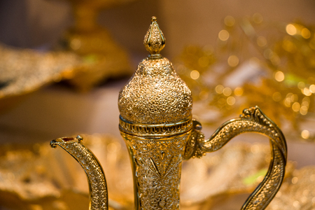 Ancient metal jug in oriental style  in antique marketの写真素材