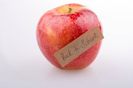 Back to school theme with a red appleの写真素材