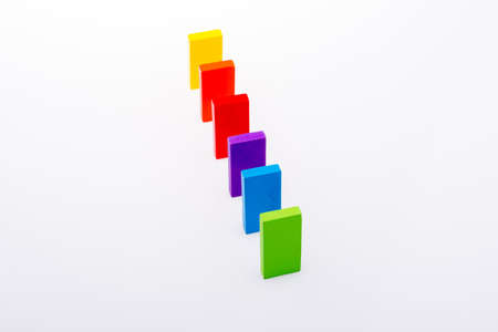 Colorful Domino Blocks in a line on a white backgroundの写真素材