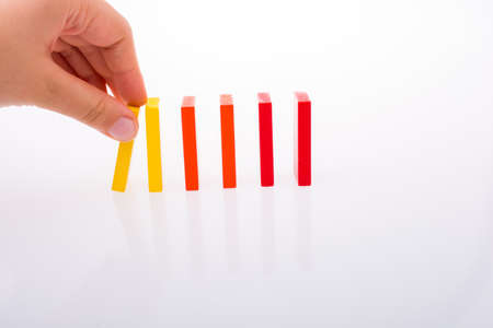 Colorful Domino Blocks in a line on a white backgroundの写真素材