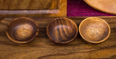 Empty bowls made of wood of brown colorの写真素材