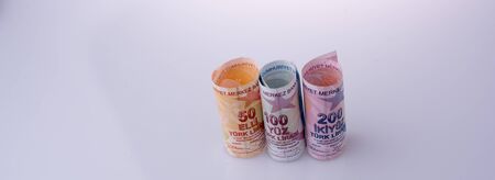 American dollar banknotes and Turksh Lira banknotes side by side on white backgroundの写真素材