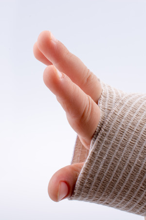 Baby wrist wrapped in bandage on white backgroundの写真素材