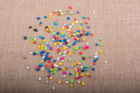 Colorful pebbles spread on a canvas backgroundの写真素材