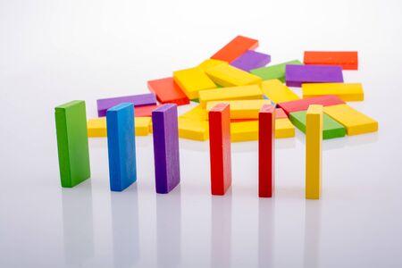 Colorful Domino Blocks in a line on a white backgroundの写真素材