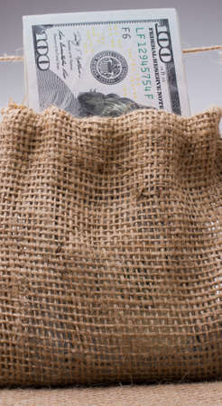 Banknote bundle of US dollarin a sack on a canvasの写真素材