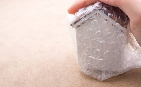 Hand holding a brand new model house in handの写真素材