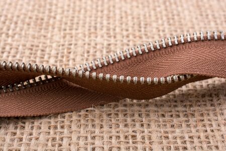 Parts of the brown color zipper on linen canvas backgroundの写真素材