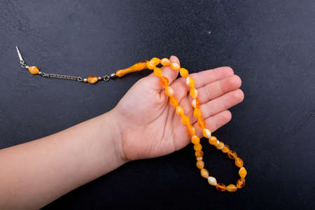 Set of praying beads of various colors on blackの写真素材