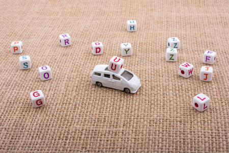 Letter cubes and  tiny toy car as a transportation deviceの写真素材