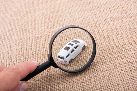 Toy car  behind a magnifying glassの写真素材