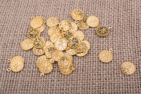 Plenty of fake gold coins are on canvasの写真素材