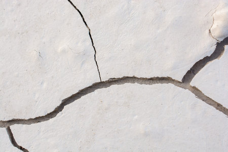 Brown color dry  cracked muddy  earth as a background texture