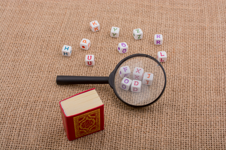 Letter cubes, magnifying glass and the Holy Quranの写真素材