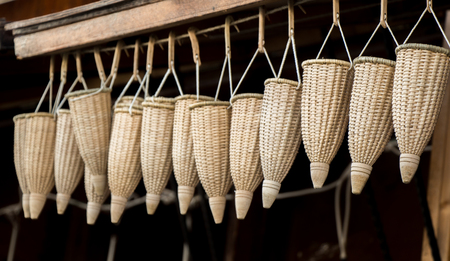 Empty wicker baskets are for sale in a marketの写真素材