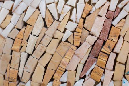 Decorative stone background built of little stonesの写真素材