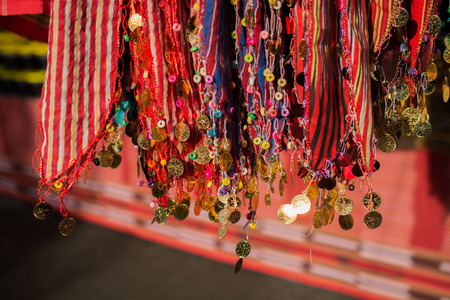 Plenty of fake gold coins are on the scarf edgesの写真素材