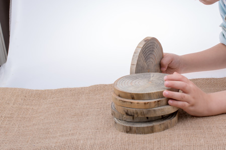 Wood Log cut in round thin pieces in handの写真素材