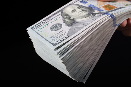 Hand holding American dollar  banknotes isolated on white backgroundの写真素材