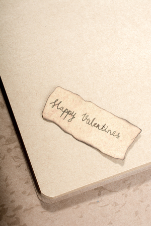 Valentine's day wording on torn paper as Love conceptの写真素材