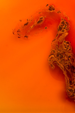 Coffe slowly dissolve in the hot waterの写真素材