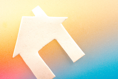 Little house cut out of paper in hand in viewの写真素材