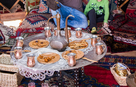 Ancient metal jug in oriental style  in antique marketの写真素材