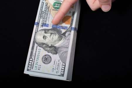 Hand holding American dollar  banknotes isolated on white background