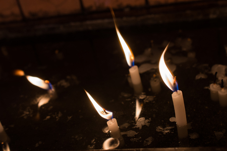 Burning candles with candle light in the darkの写真素材