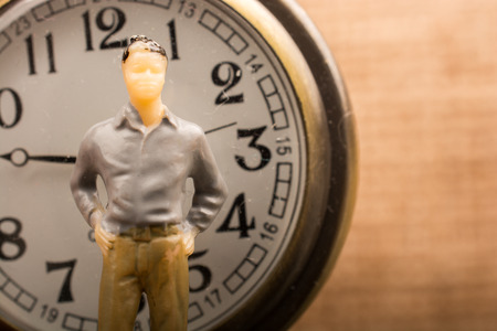 Mechanical retro pocket watch  and a man figurineの写真素材