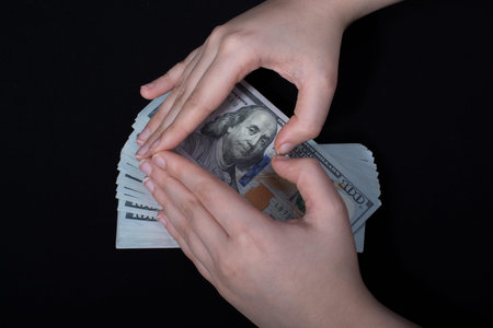 Hand holding American dollar  banknotes isolated on white background