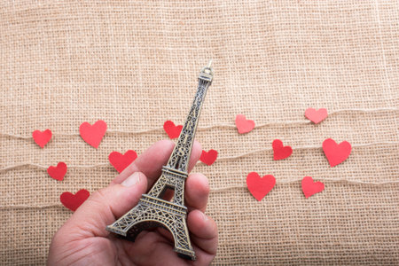 Love concept with Eiffel tower and paper heart on threadsの写真素材