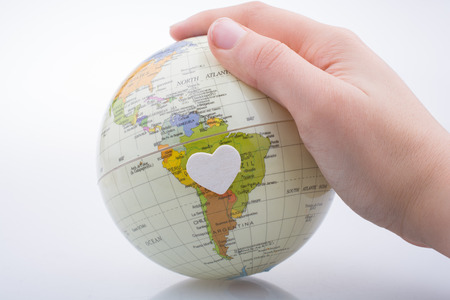 Hand holding a globe  with map on itの写真素材