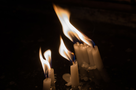 Burning candles with candle light in the darkの写真素材