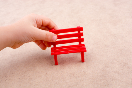 Little red miniature bench made of plasticの写真素材
