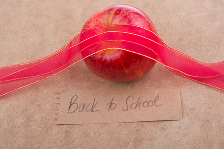 Back to school lettering with apple and a red ribbonの写真素材