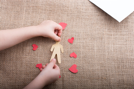 Man and heart  shape cut out of paper in handの写真素材